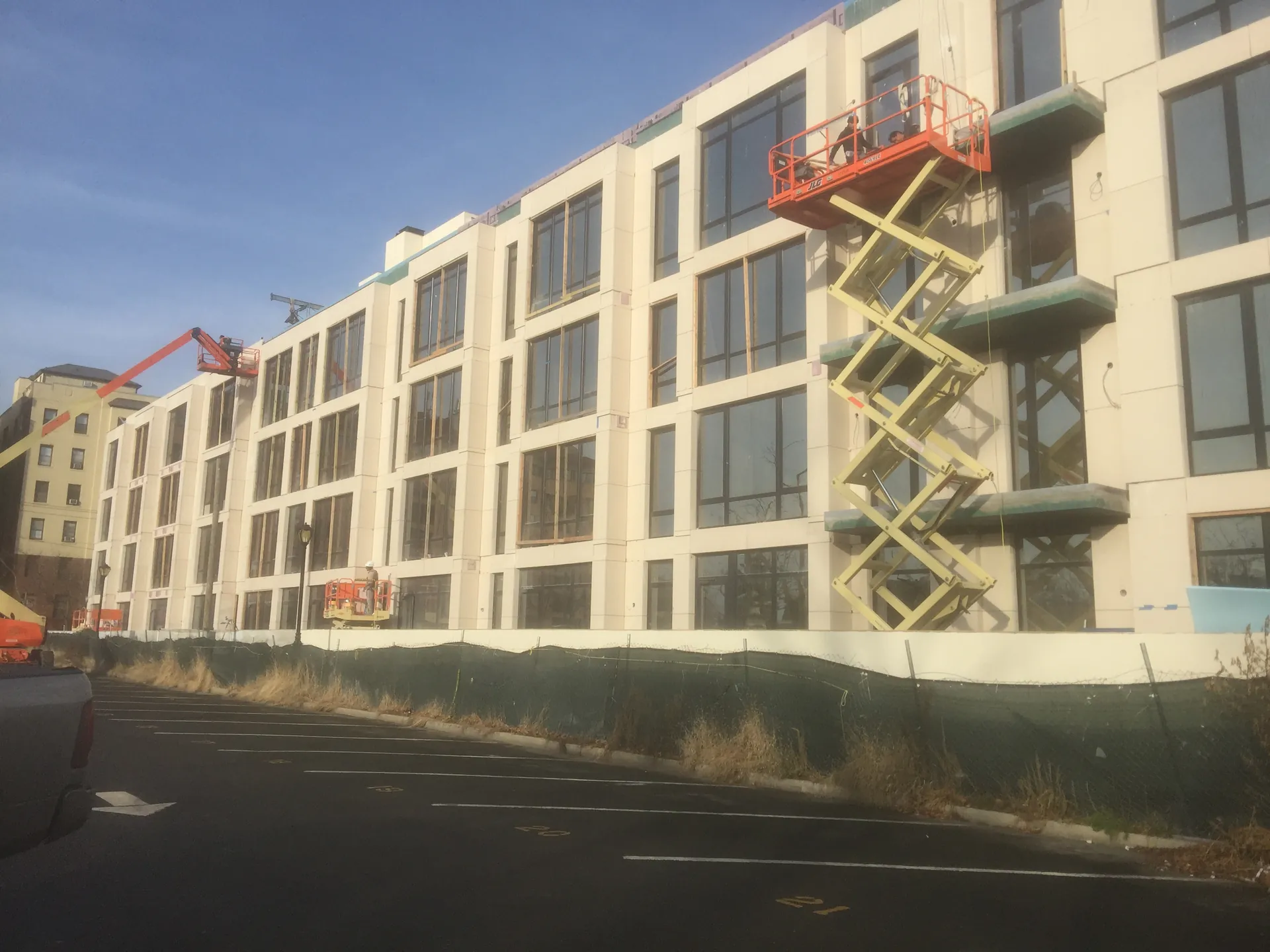 Exterior of a modern apartment complex at sunset