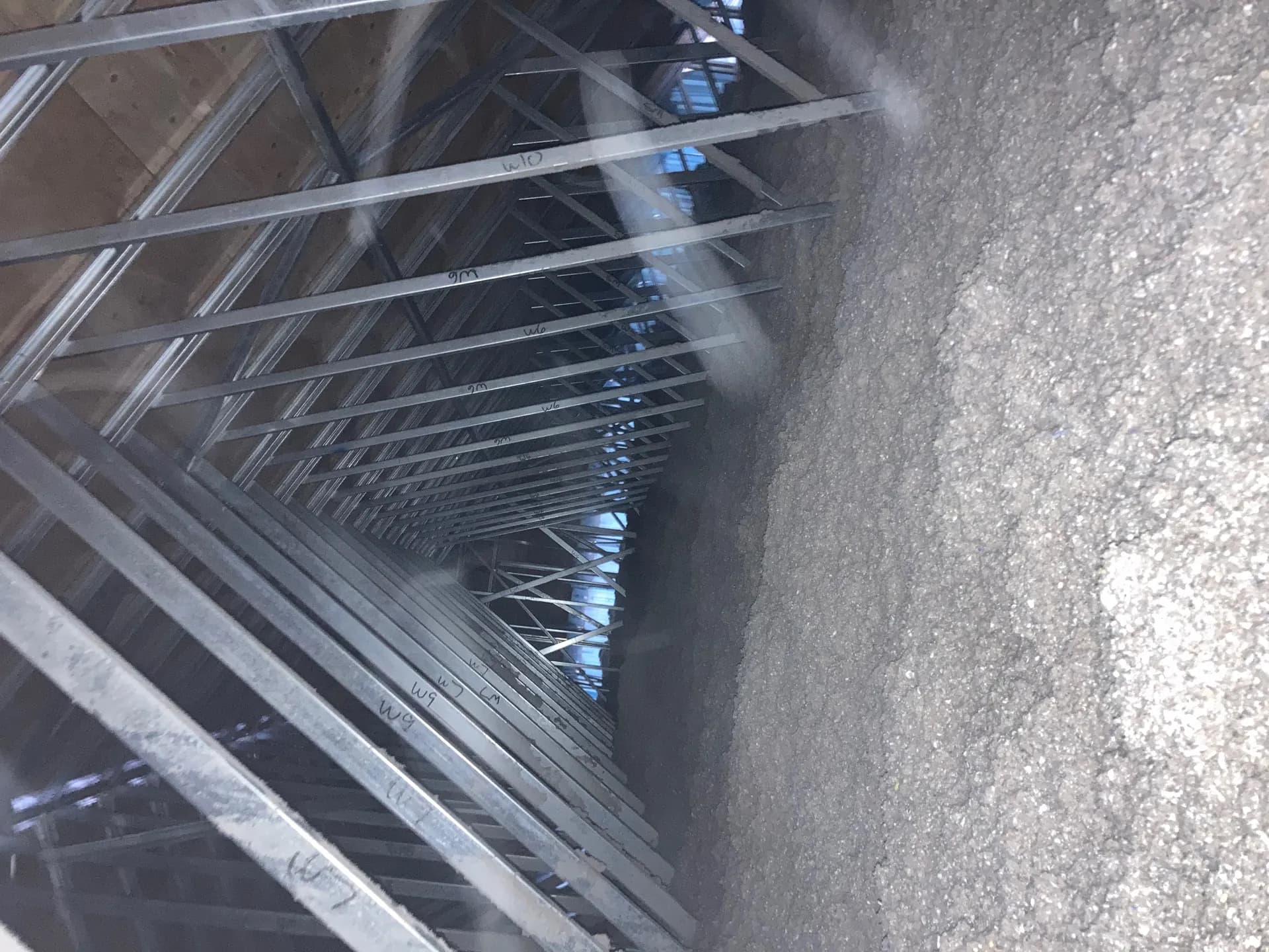 Contractors retrofitting a building with cellulose insulation