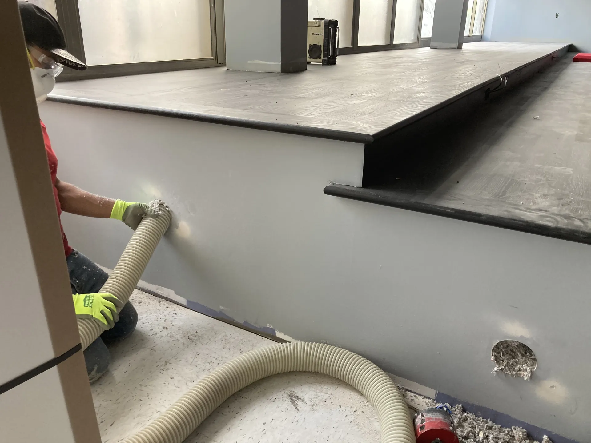 Technician dense-packing cellulose insulation for sound control